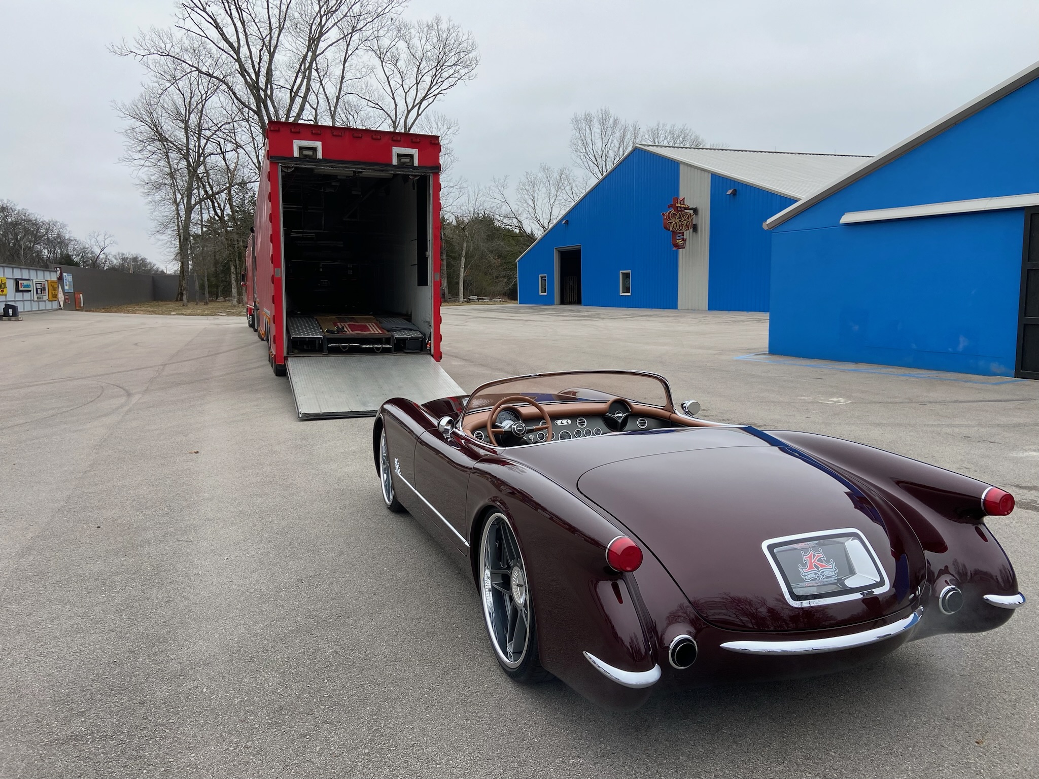 picture of sewell and sons loading a classic car onto transport trailer.